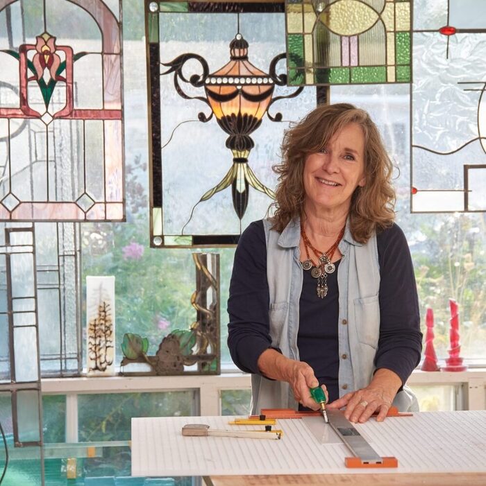 A maker at work in a stained glass studio
