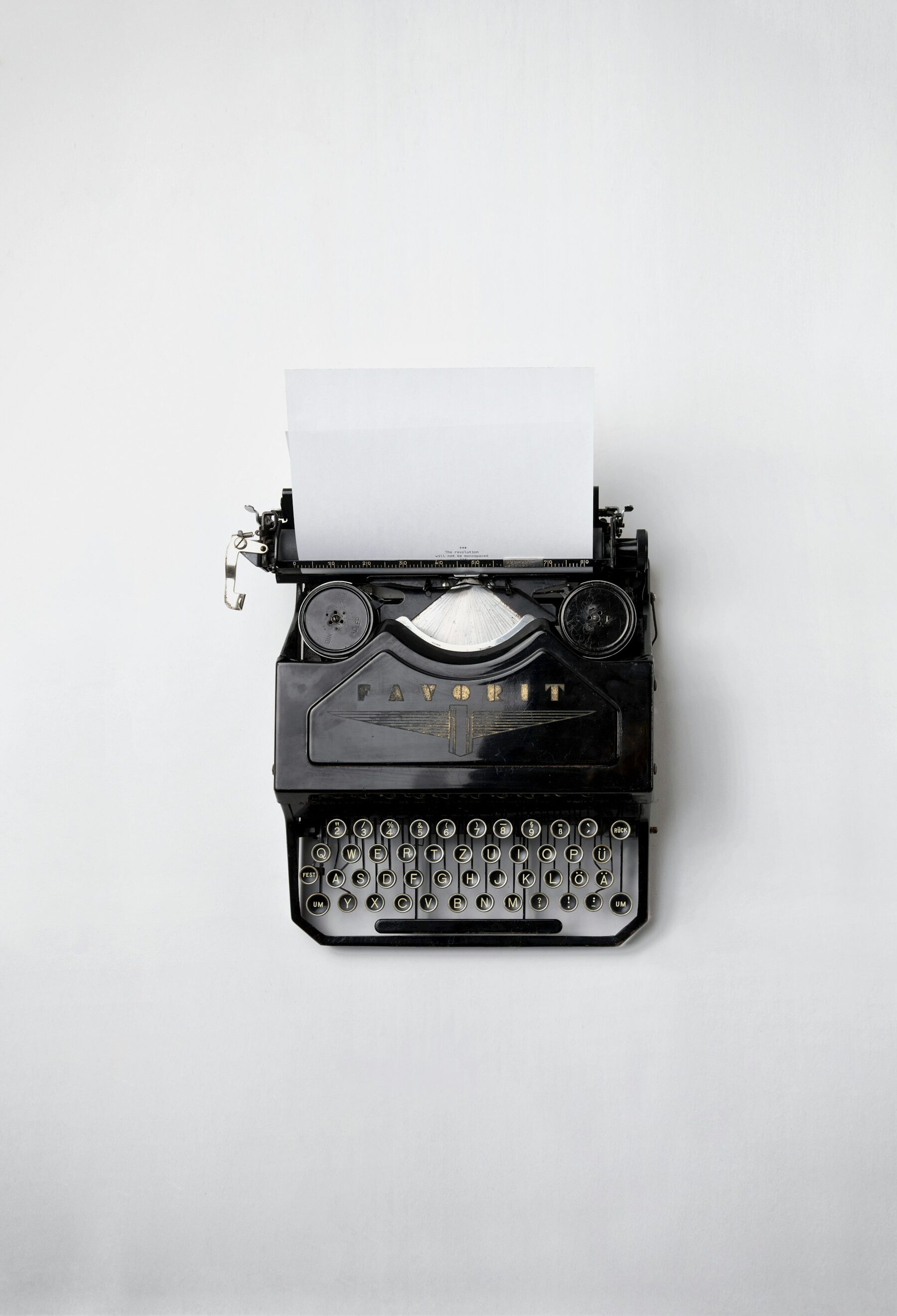 Black typewriter with paper